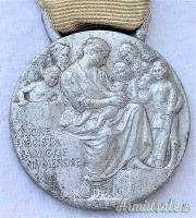 Medaglia d’epoca fascista cosiddetta “D’ONORE PER LE MADRI DI FAMIGLIE NUMEROSE” con 7 fiocchi